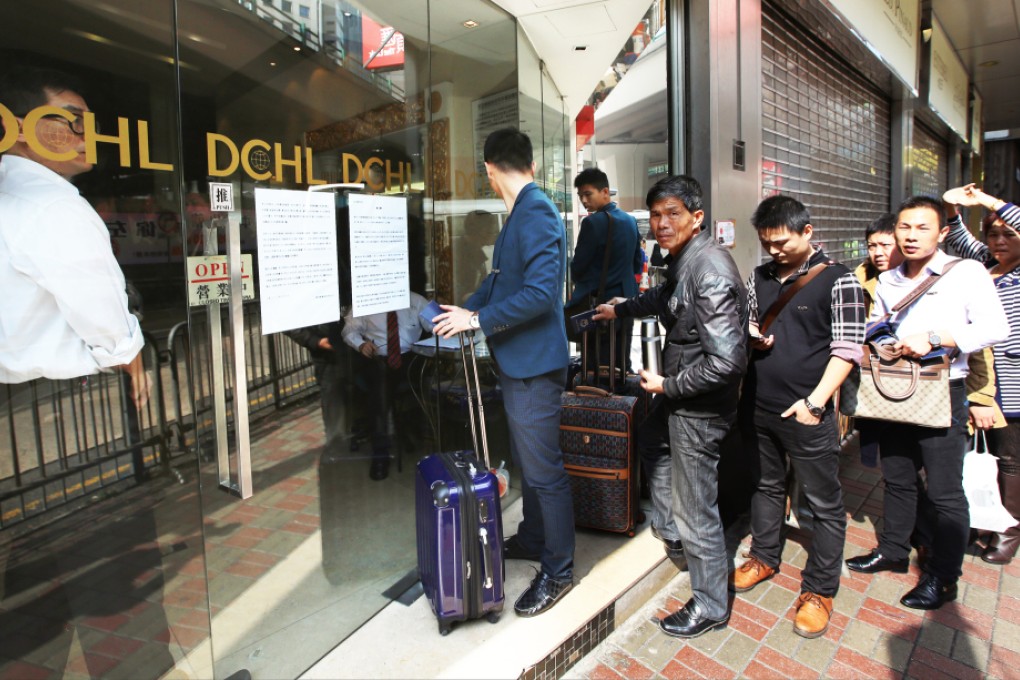 Mainland sales agents stands outside DCHL's office at Causeway Bay.