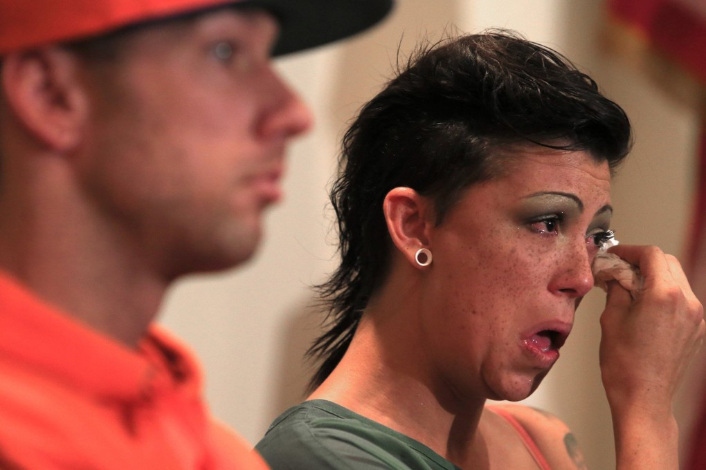 Adult film performer Cameron Bay, right, wipes her eyes after telling her story about testing positive for HIV during a news conference in Los Angeles.