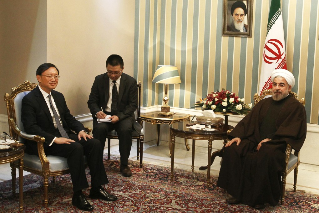 State Councilor Yang Jiechi (left), the country's top diplomat, meets Iranian President Hassan Rowhani (right) during his visit to Tehran on Sunday. Photo: Xinhua
