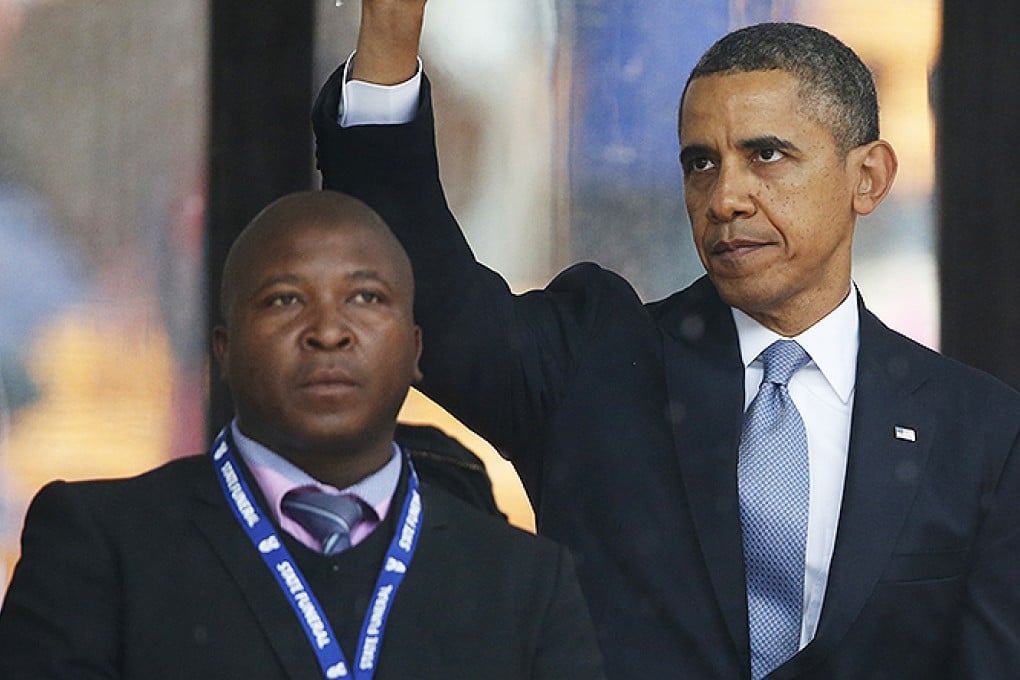 President Barack Obama stands next to the sign language interpreter accused of being a fake. Photo: AP