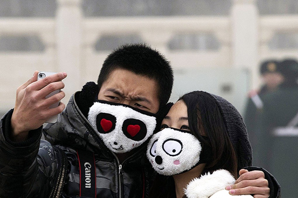 A couple braving the smog in Tiananmen Square. Photo: AP