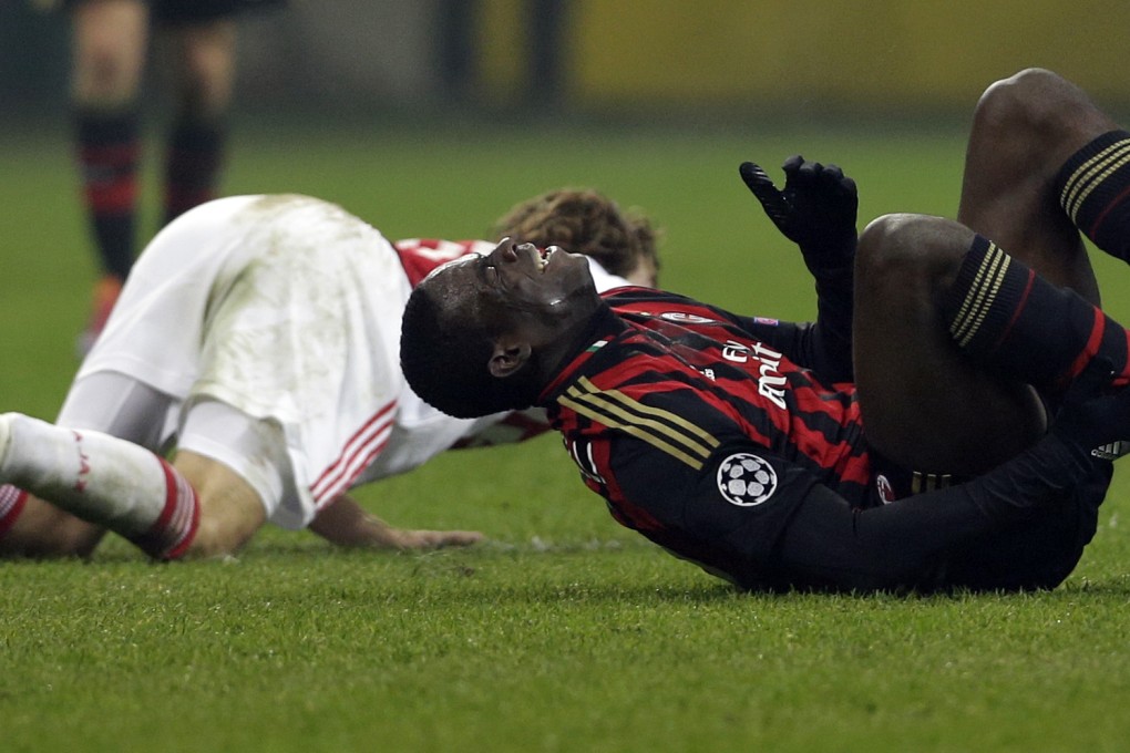 AC Milan forward Mario Balotelli grimaces in pain after being fouled by Ajax's Daley Blind. Balotelli had a strong performance leading his side against Ajax at the San Siro. Photo: AP