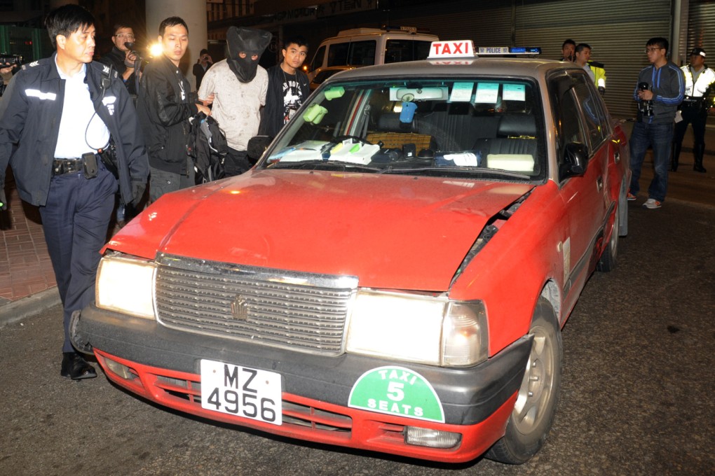 Police arrest the man, who had allegedly driven a stolen taxi for three months despite being banned from driving. Photo: SCMP