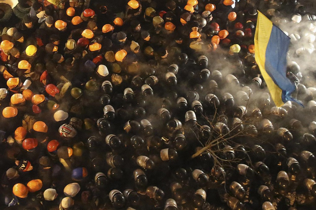 Pro-European protesters scuffle with riot police in downtown Kiev. Thirty people had sought medical aid by mid-morning. Photo: Reuters