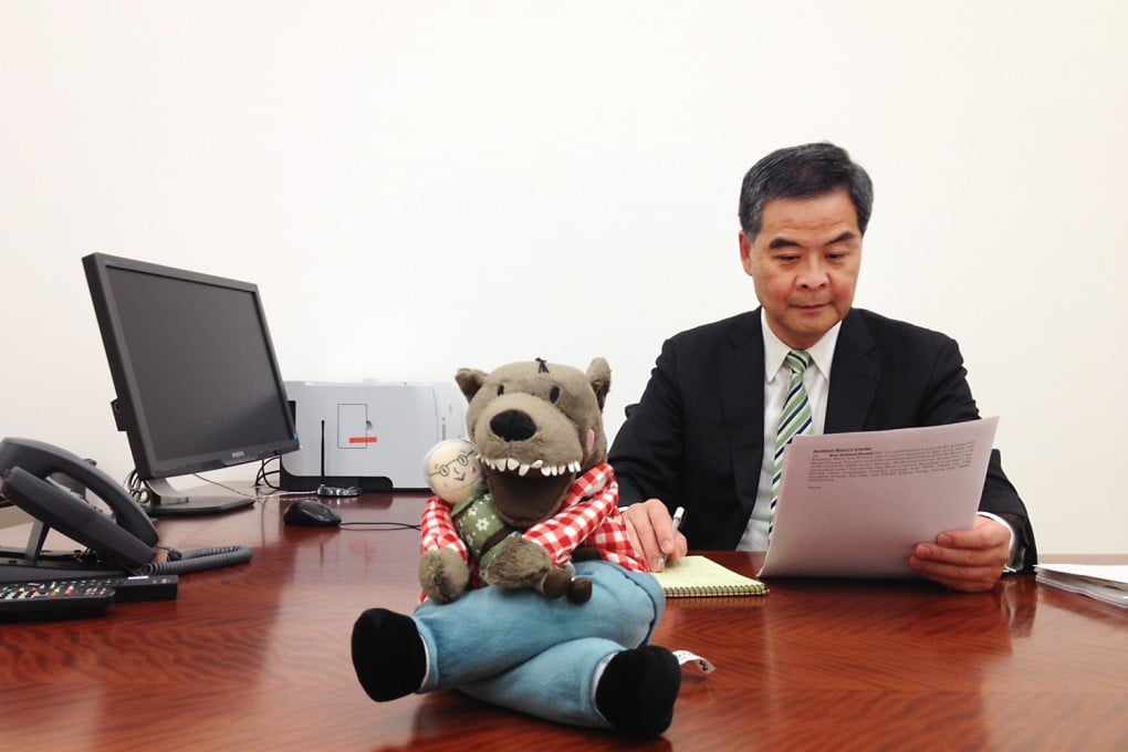 Leung Chun-ying meets Lufsig, the toy used to mock Leung''s reputation as a "wolf". Photo: SCMP