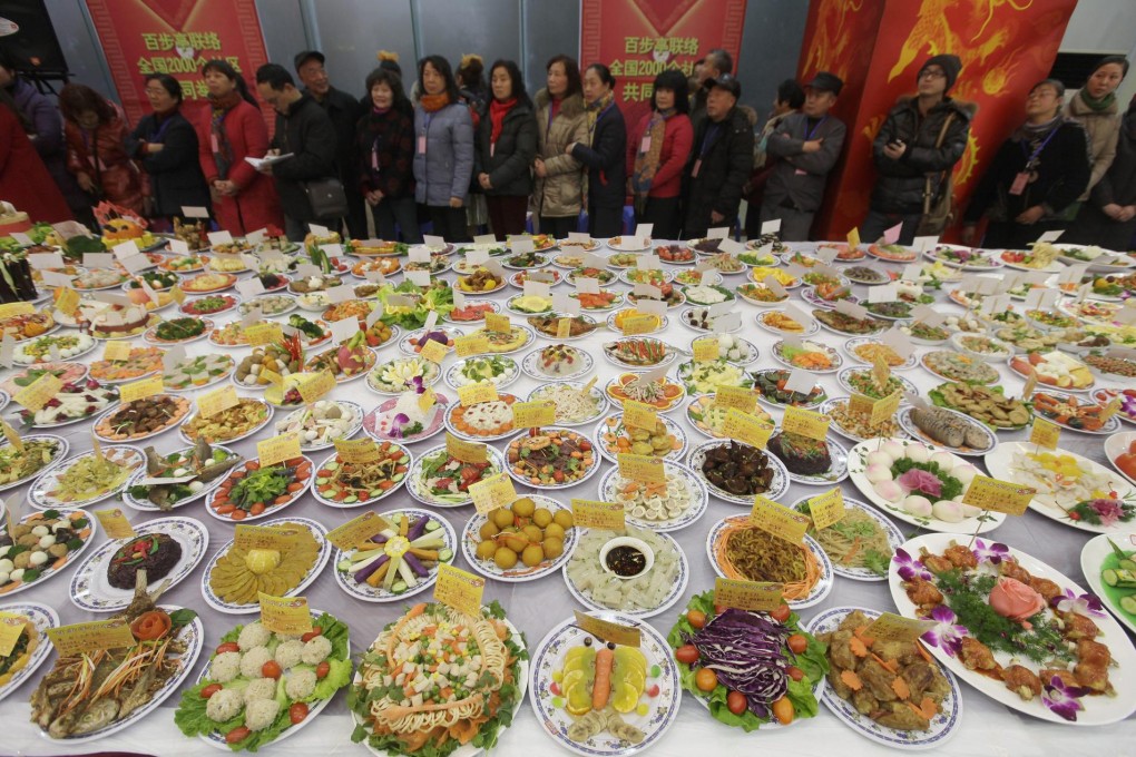 People in Wuhan in Hubei province admire hundreds of dishes designed and prepared for the Lunar New Year's Eve dinner in January. Photo: EPA