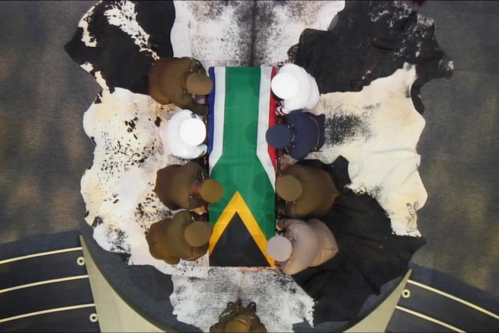 Nelson Mandela's coffin is carried by military personnel at the end of his funeral service in his ancestral village of Qunu. Photo: Reuters