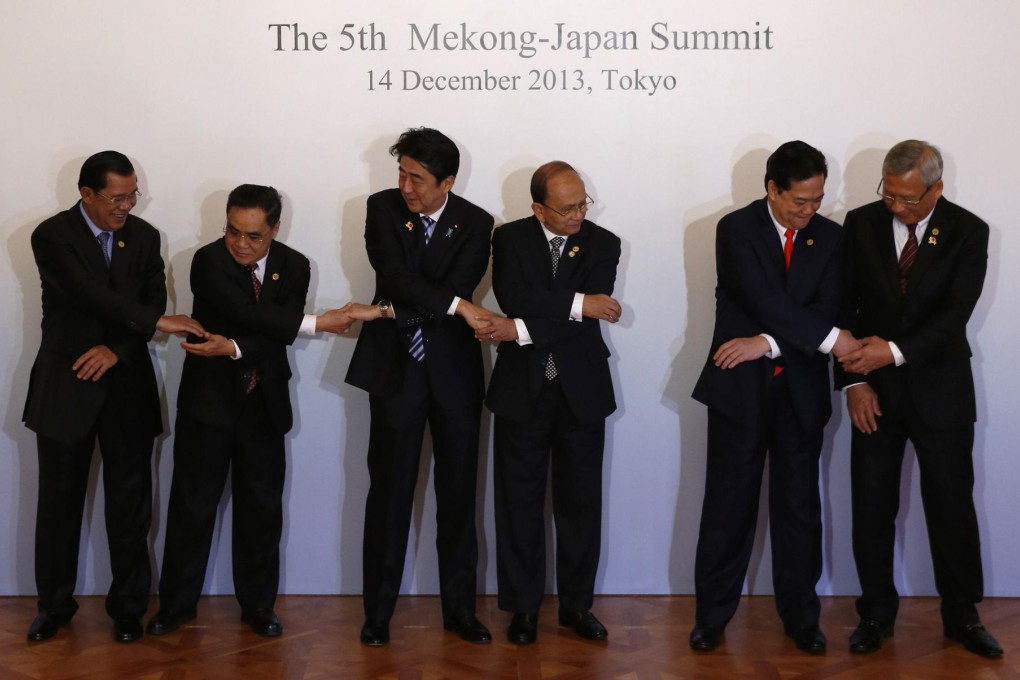 Japanese Prime Minister Shinzo Abe (third left) prepares to pose for a photo session with Asean leaders in Tokyo yesterday, the first major gathering of regional leaders since China's declaration of a controversial air defence identification zone in November. Photo: AFP