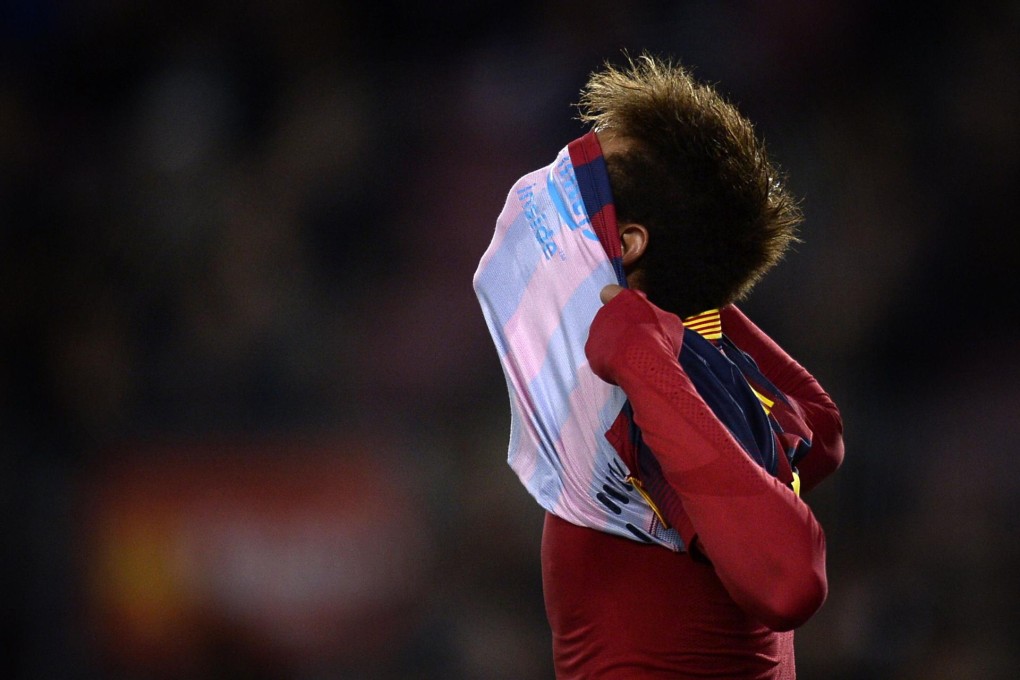 Pulling his shirt over his face, Neymar celebrates one of the two goals he scored for Barcelona against Villarreal in La Liga. Photo: AFP