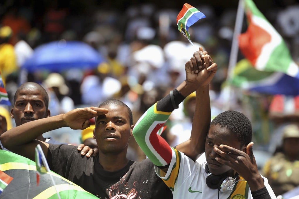 South Africans show their emotion as they watch a broadcast of Mandela's funeral at the Orlando Stadium in Johannesburg. Photo: Reuters