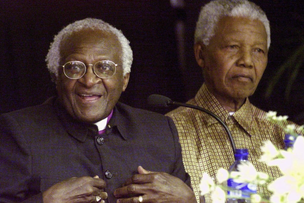 Desmond Tutu and former President Nelson Mandela, pictured in 2001. The retired Archbishop has said he will attend Mandela's funeral. Photo: Reuters
