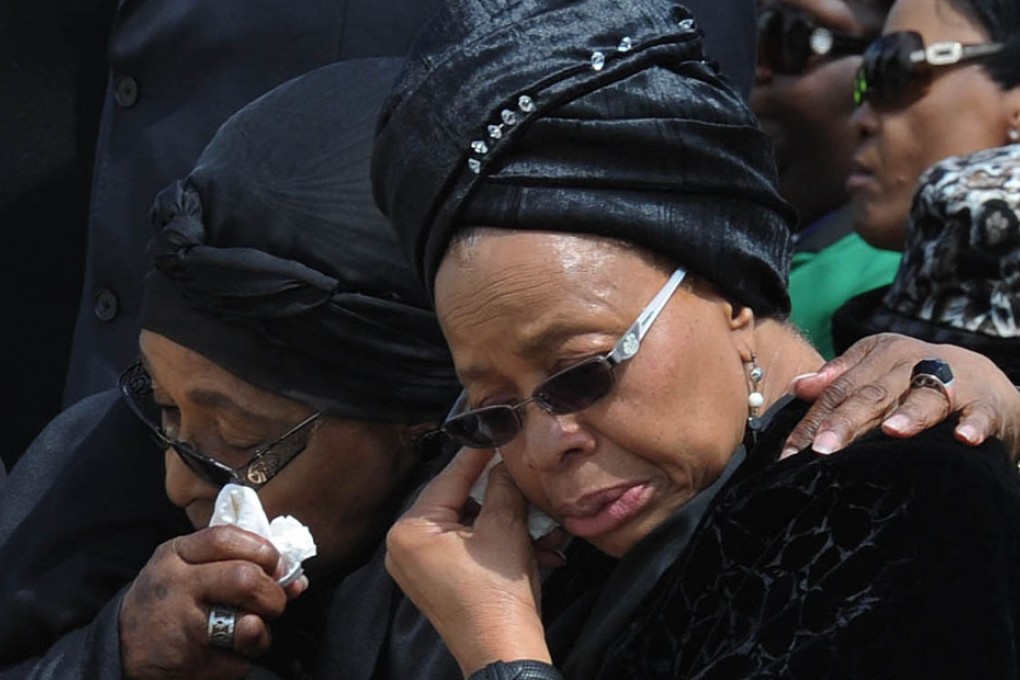 Ex-wife Winnie Mandela Madikizela (left) and widow Graca Machel wipe their tears during a memorial to Nelson Mandela. Photo: AFP