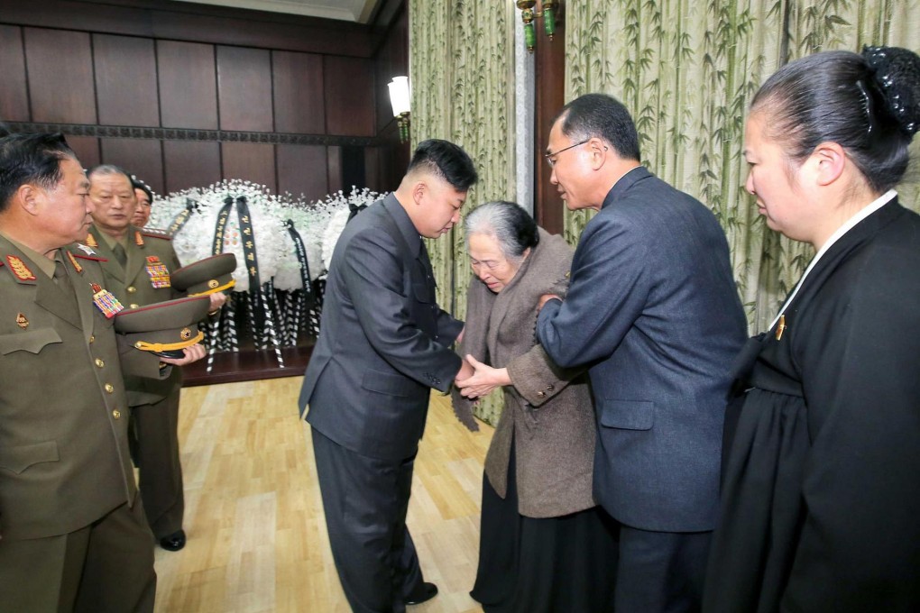 North Korean leader Kim Jong-un (centre left) meets with family of the late Kim Kuk Thae. Photo: AFP