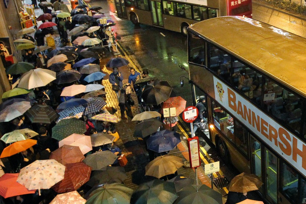 It was a sea of umbrellas outside Kwun Tong station as frustrated passengers waited for shuttle buses in the rain. Photo: SCMP