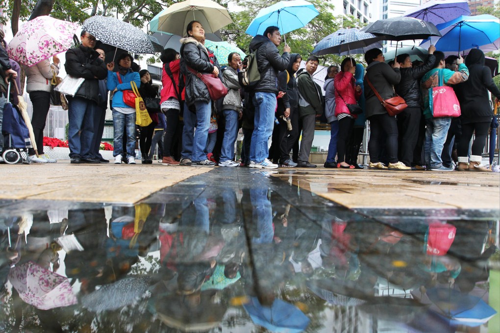 Rain did not bother the crowds of shoppers waiting to get into the Brands and Products Expo at Victoria Park yesterday. Photo: Sam Tsang
