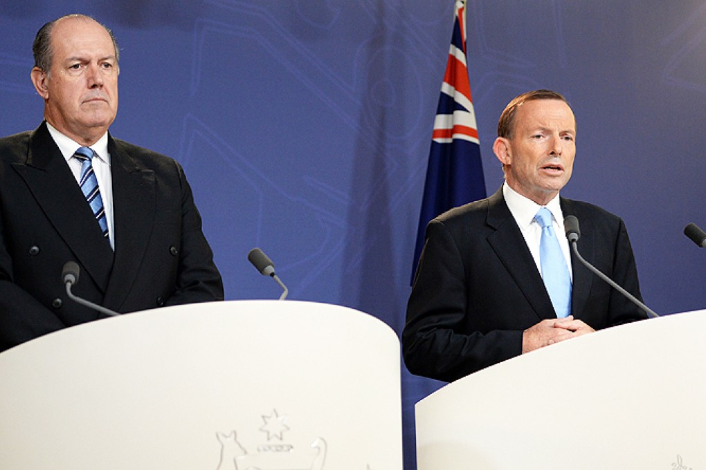 Australian Prime Minister Tony Abbott (right) speaks at a press conference along with Defence Minister David Johnston in Sydney on Monday. Photo: AFP