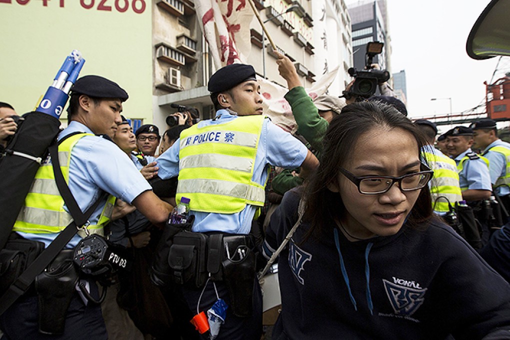 A protester breaks free from a police cordon at the opening ceremony of Bi-city Biennale of Urbanism. Photo: Reuters