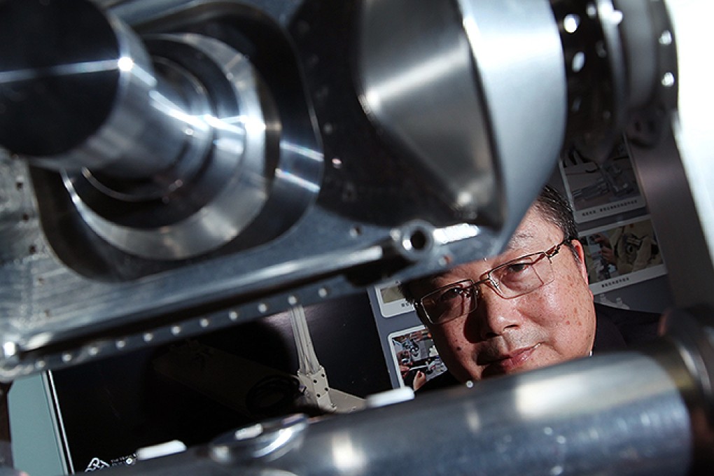 Professor Yung Kai-leung with the camera pointing system he developed at Hong Kong PolyU. Photo: Nora Tam