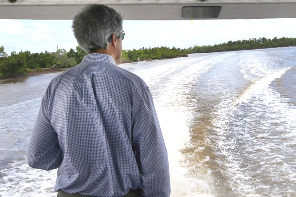 US Secretary of State John Kerry rides a boat through the Mekong River Delta. Photo: Reuters