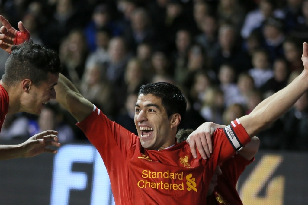 Luis Suarez celebrates after scoring the first of his two goals in Liverpool's 5-0 win over Spurs on Sunday. Photo: AP
