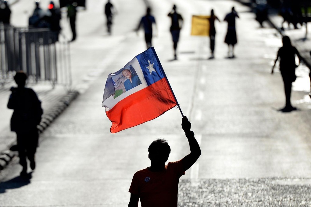 Supporters of Chilean socialist candidate Michelle Bachelet celebrate victory in front of the headquarters of her New Majority coalition in Santiago on Sunday. Photo: AFP