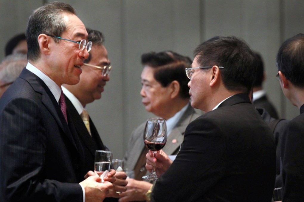 Henry Tang and Ip Kwok-him chat at a gathering yesterday of former and current lawmakers at the Legislative Council. Photo: Dickson Lee