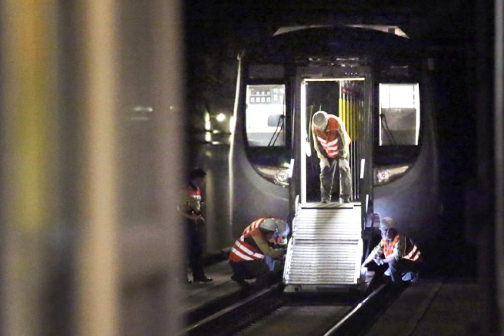 MTR staff inspects a train in Yau Tong Station after train services are suspended due to a power supply fault. Photo: K.Y. Cheng