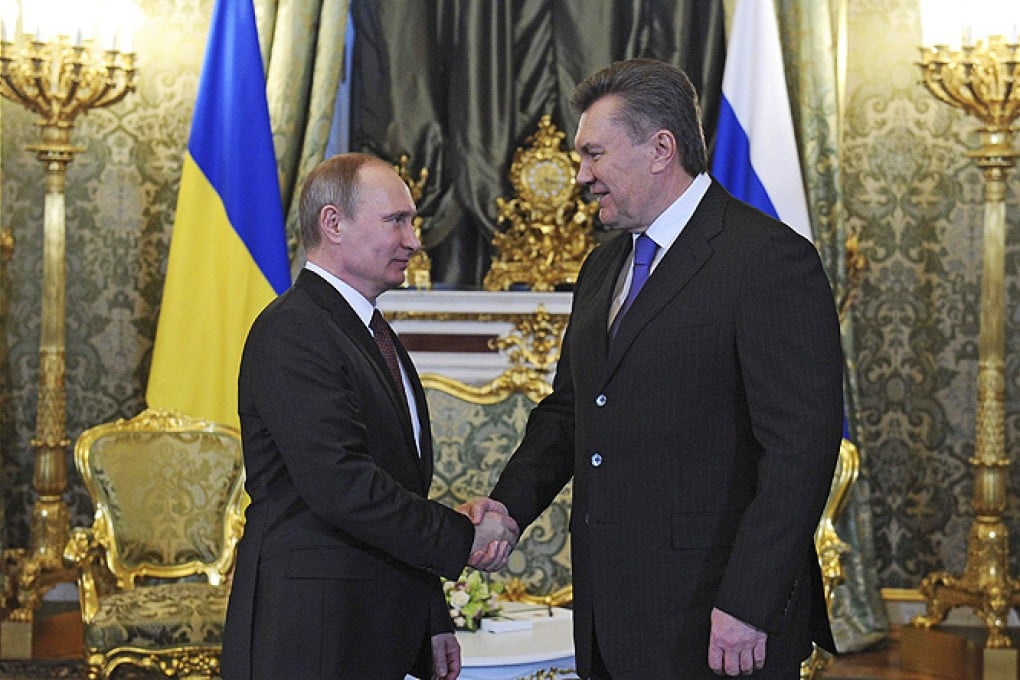 Russia's President Vladimir Putin (left) shakes hands with his Ukrainian counterpart Viktor Yanukovich during a meeting at the Kremlin in Moscow, on Tuesday. Photo: Reuters