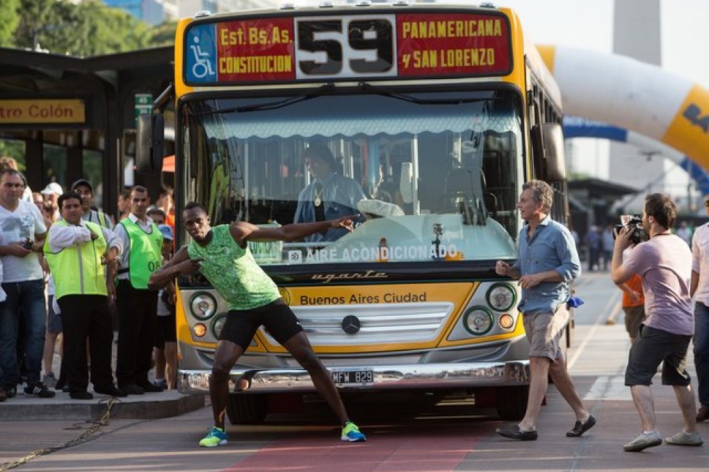 Usain Bolt  after beating a bus in a race in the "9 de Julio" Avenue, in Buenos Aires, Argentina, on Sunday. Photo: Xinhua