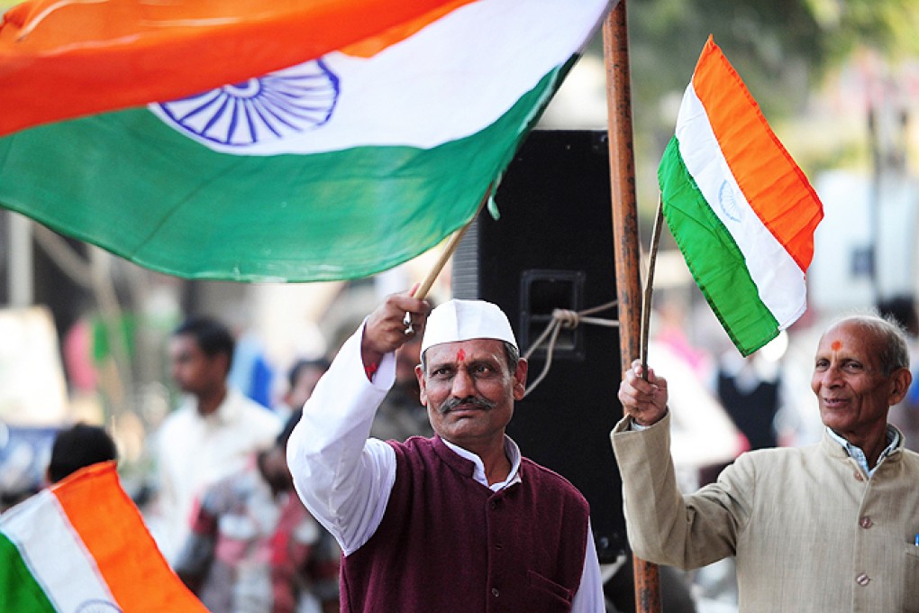 Indian supporters of activist Anna Hazare celebrate after parliament passed the Lokpal Act in Allahabad on Wednesday. Photo: AFP