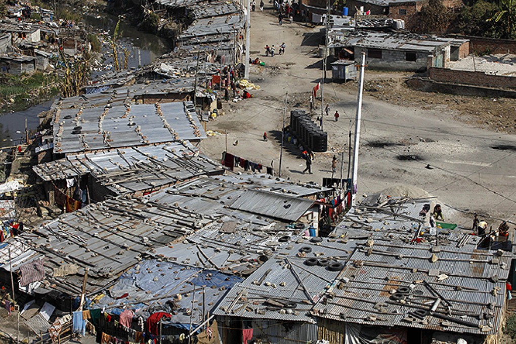 Shabby tin-roofed huts house more than 10,000 people along the banks of the Bagmati river in Kathmandu. Photo: AFP