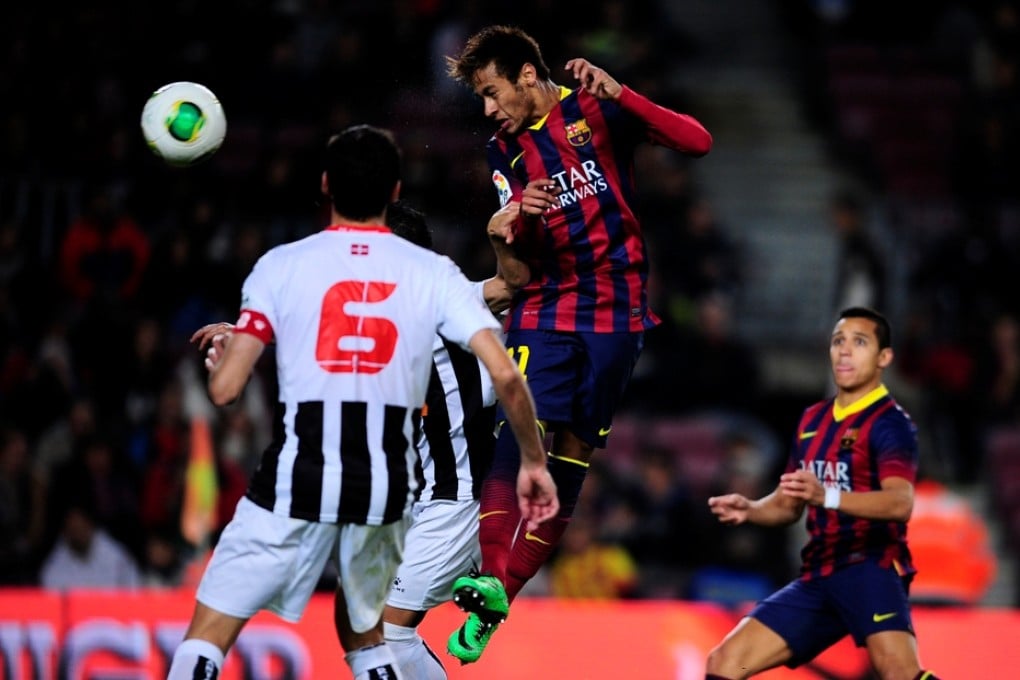 Neymar heads home against Cartagena to help secure Barcelona's last-16 place in Spain's Copa del Rey. Photo: AP