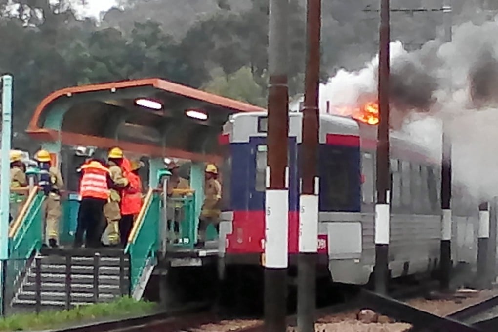 Firefighters tackle a blaze on an MTR light-rail train in Tin Shui
Wai yesterday. Photo: SCMP