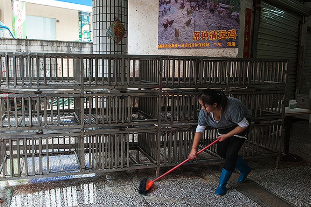 A worker disinfects a meat and vegetable market in Longgang, Shenzhen. Photo: Xinhua