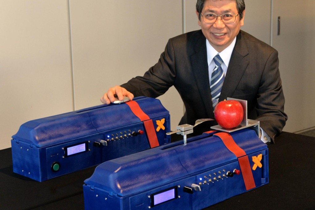Kohei Onishi displays the "force transceiver". Photo: AFP