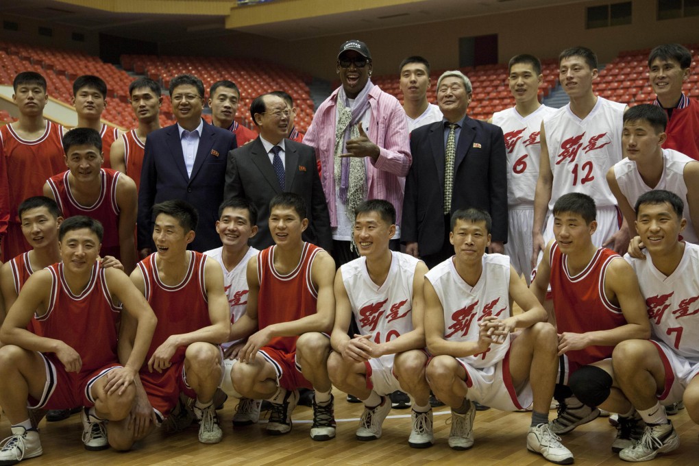 Former NBA basketball star Dennis Rodman poses with North Korean basketball players during a practice session in the North Korean capital Pyongyang. Photo: AP