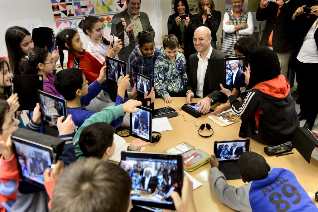 Swedish Prime Minister Fredrik Reinfeldt visits a school west of Stockholm. Photo: AFP