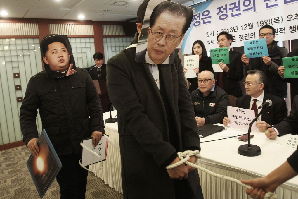 South Korean college students wearing masks of North Korean leader Kim Jong-un (left) and his uncle Jang Song-thaek are pictured during a press conference in Seoul, denouncing Kim's dictatorship and alleged human rights violations. Photo: AP.