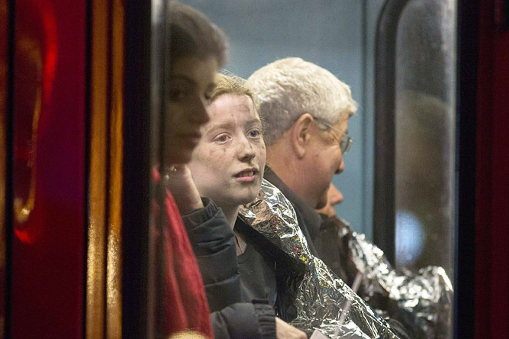 People receive medical attention on a bus after part of the ceiling at the Apollo Theatre on Shaftesbury Avenue collapsed in central London on Thursday. Photo: Reuters