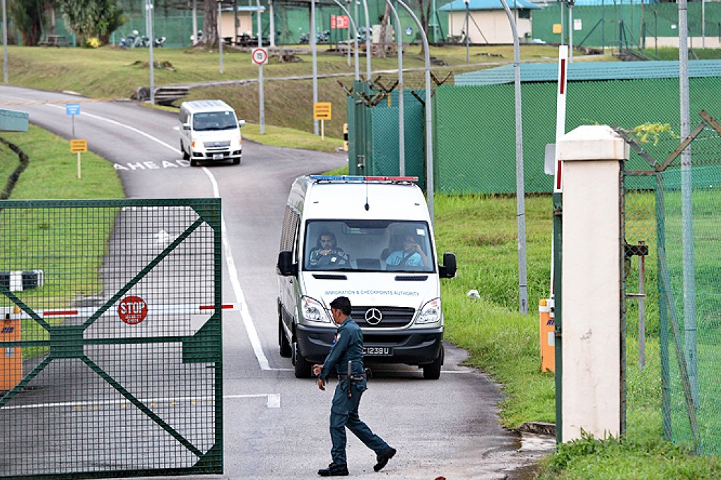 An Immigration and Customs Authority van, transporting arrested foreign workers, leaves Admiralty West Prison in Singapore. Photo: AFP