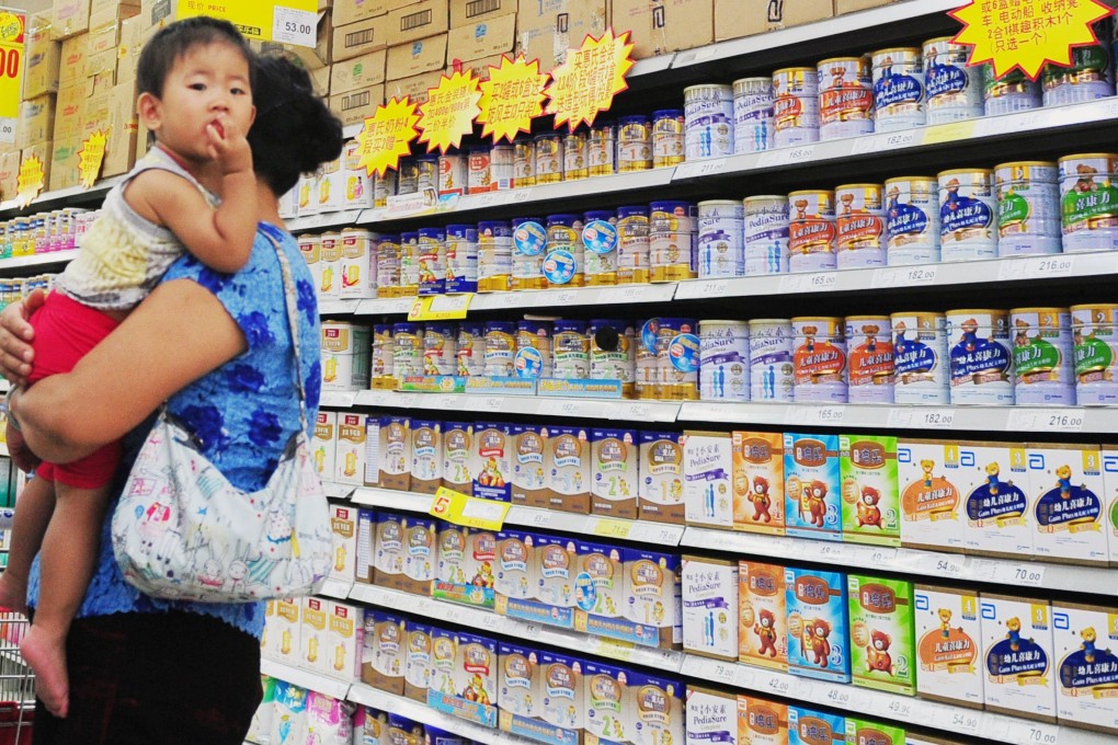 A Chinese woman selects milk powder for her child at a supermarket in Beijing. Photo: AFP