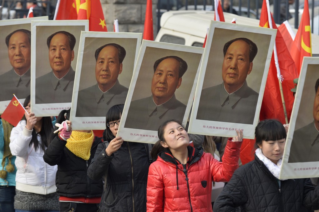 Students hold portraits of Mao during an event in Taiyuan , in Shanxi , ahead of the 120th anniversary his birth. Photo: Reuters