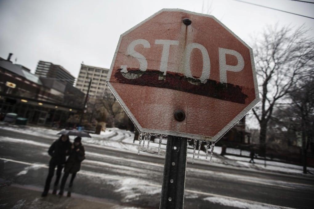 A frozen stop sign seen in Toronto on Monday after the ice storm at the weekend. More than 300 flights to the Canadian city were cancelled. Photo: Reuters