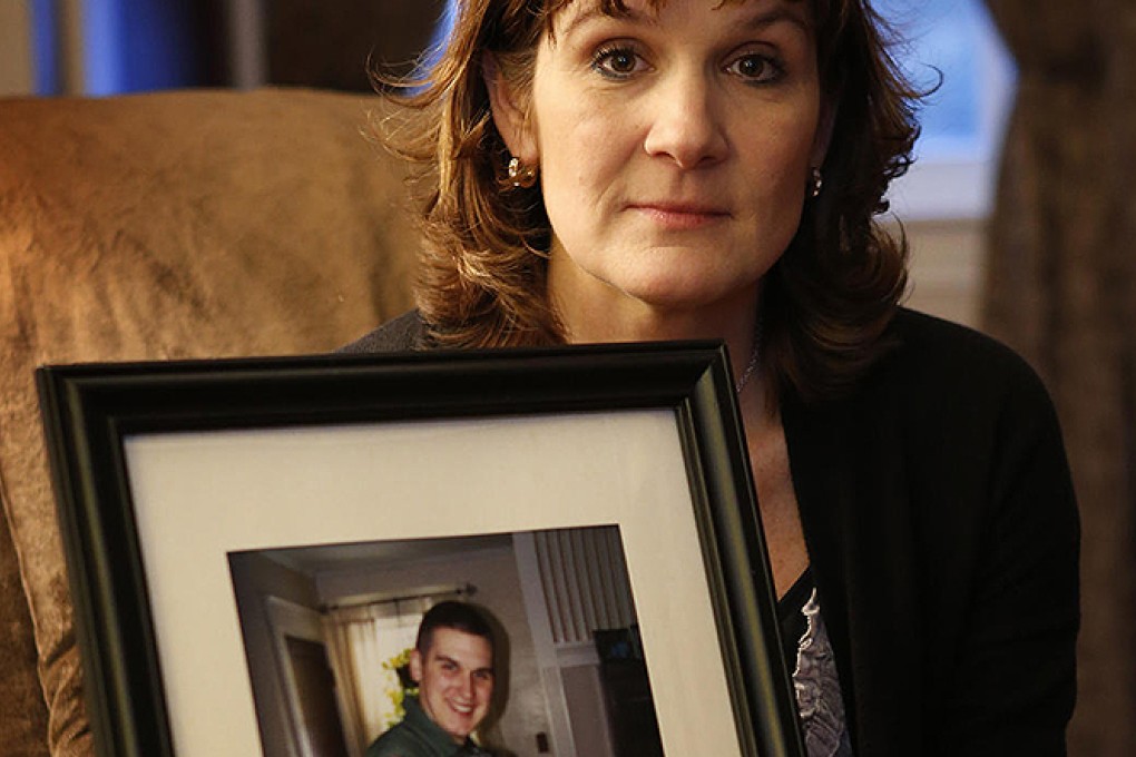 Hallie Twomey with a photo of her dead son. Photo AP