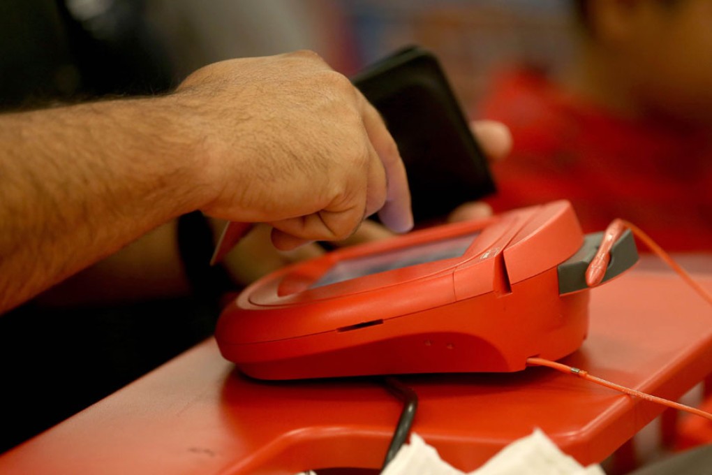 A customer uses the credit card scanner at a Target store in Miami. Photo: AFP