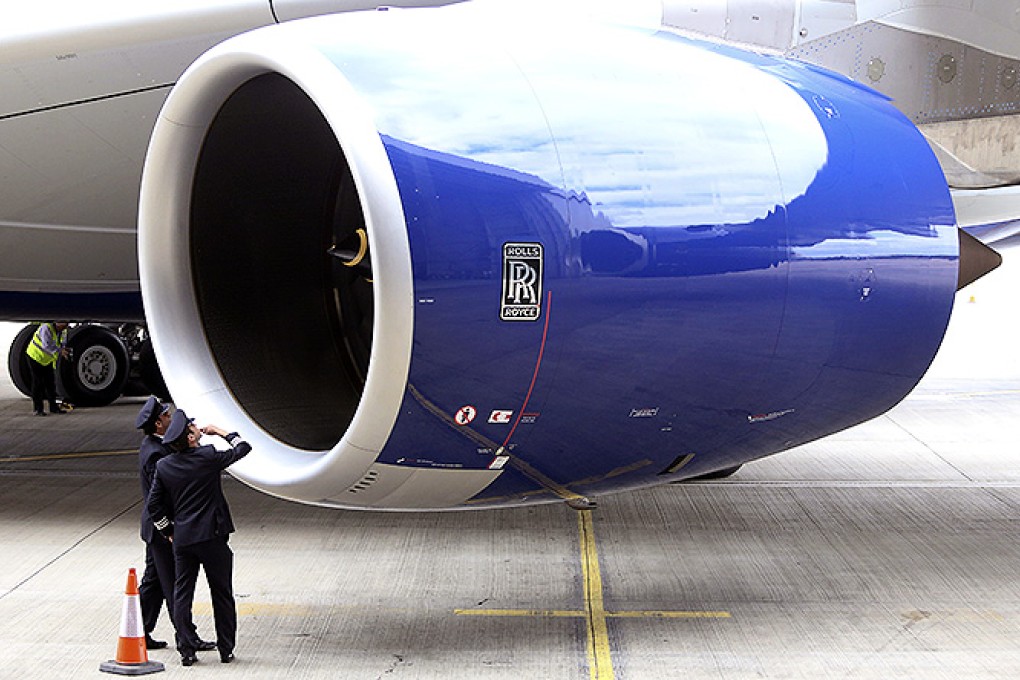 A flight crew look inside the cowling of a Rolls-Royce Holdings Trent 900 engine on the new Airbus A380 aircraft operated by British Airways. Photo: Bloomberg
