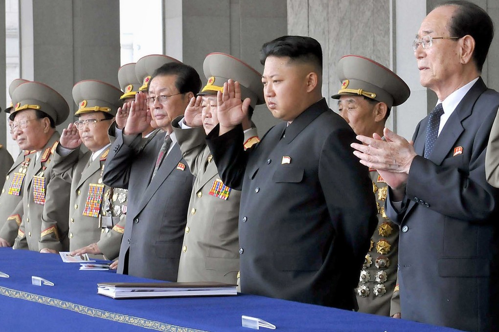 Kim Jong-un (second from right) wanted the military to regain control of the seafood trade, but his uncle refused to give up control, a new report says. Photo: AFP