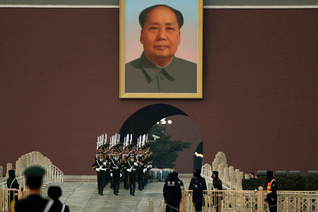Chinese para-military police march beneath a portrait of late leader Mao Zedong beside Tiananmen Square in Beijing on December 13, 2013. Photo: AFP