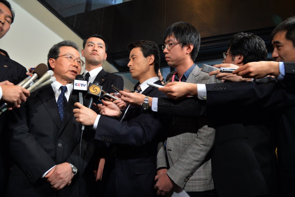 China's ambassador to Japan Cheng Yonghua (left) is surrounded by reporters after he met with Japan's vice-Foreign Minister Akitaka Saiki in Tokyo on Thursday. Photo: AFP