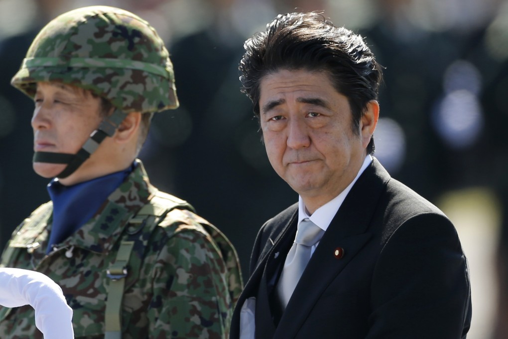 Japanese Prime Minister Shinzo Abe (right) in October reviews the Self-Defence Forces, the de facto military allowed for in the country's pacifist constitution. Photo: Reuters